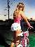 britney spears dressed provocatively in pink and white pushing her bicycle home